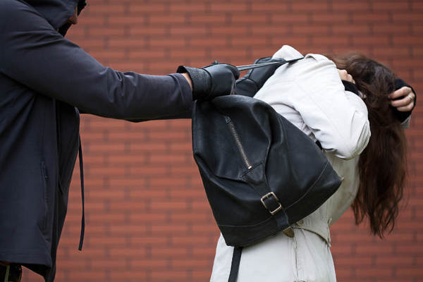 Dangerous masked man is assaulting a student to steal a backpack