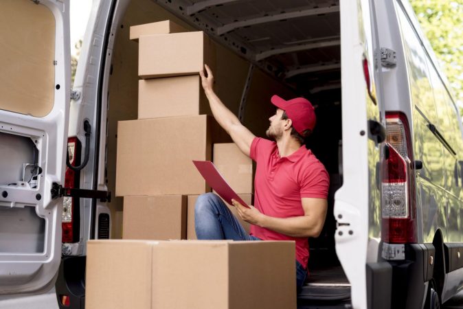 low angle delivery man with package list scaled 1 Merca2.es