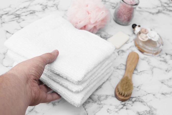 mano humana recogiendo pila toallas Merca2.es