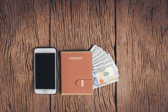 top view passport with money wood background tourism concept Merca2.es
