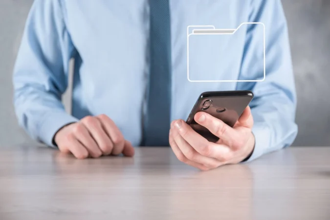 businessman hold folder icon document management system dms setup by it consultant with modern computer are searching managing information corporate files business processing Merca2.es