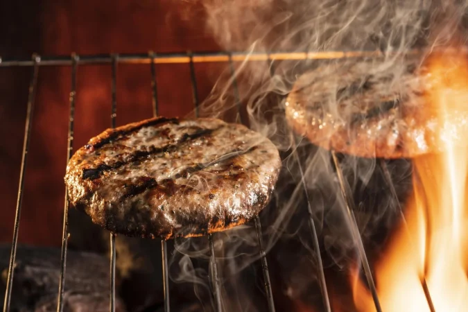 Smash burger: Cómo preparar la hamburguesa perfecta en casa 3 Merca2.es high angle burger meat grill Merca2.es
