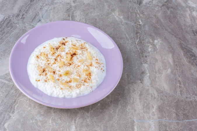 un plato morado lleno de gachas de avena saludables con canela en polvo Merca2.es